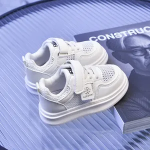 Detail of white mesh kids sneakers with velcro strap and durable rubber sole