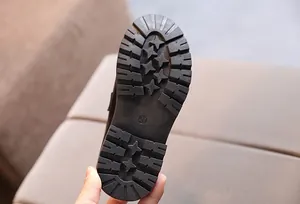 Close-up of children's leather shoe anti-slip sole with size 31 marking and deep tread