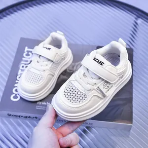 Detail of white breathable mesh sneaker with Velcro strap and thick cushioned sole