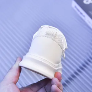 Detail showing the white pull tab and mesh lining on a breathable children's sneaker