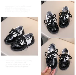 Gros plan de chaussures richelieu noir et blanc pour enfants avec détails perforés