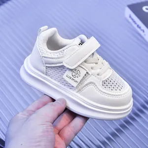 Macro shot of white breathable mesh panel and leather trim on kids athletic sneaker