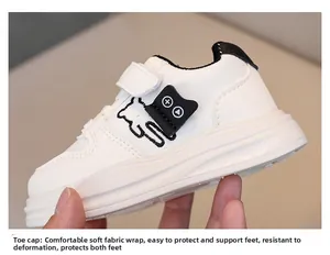 Detail of white leather toddler sneaker featuring cat embroidery and soft cushioned sole