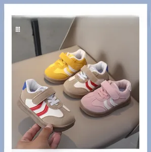 Detailed view of non-slip rubber soles and velcro straps on breathable kids' sneakers