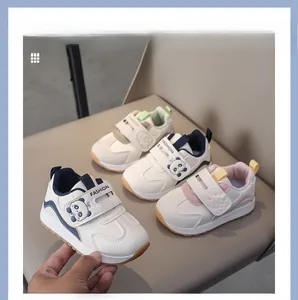 Detail of toddler sneakers with cartoon panda motifs and durable non-slip rubber soles