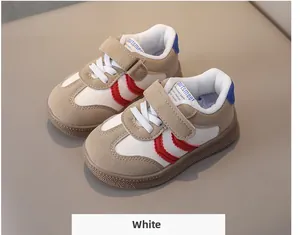 Detail of kids sports shoes with red wave stripe, velcro strap and non-slip rubber sole