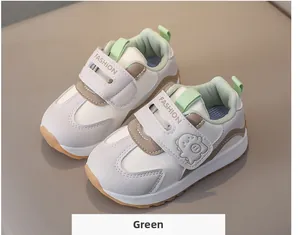 Detail of toddler sneakers with double velcro straps, fashion logo, and green fleece lining