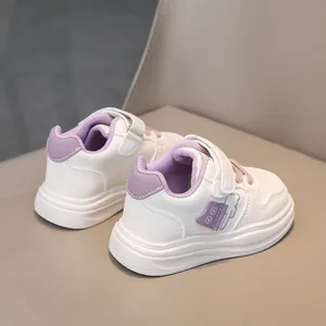 Detailed back view of children's white faux leather sneakers with purple cat patches