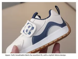 Detail of toddler white sneaker with navy wave pattern, velcro panda tab and rubber sole
