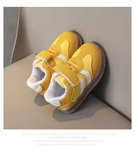 Detail view of yellow children sneakers with velcro strap and non-slip rubber soles