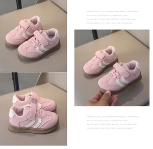 Detail of pink toddler sneaker with leather upper, hook and loop strap, and rubber sole