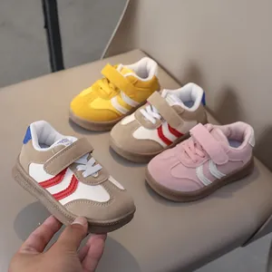 Detailed macro view of vintage kids sneakers with velcro straps and gum rubber soles