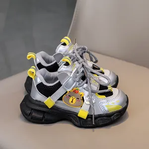 Detail of kids sporty sneakers featuring silver mesh, cartoon bear and velcro strap