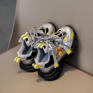 Detail of children's mesh sneaker featuring yellow straps and cartoon bear design