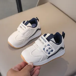 Detail view of toddler walking shoes featuring a cute cartoon panda and velcro closure