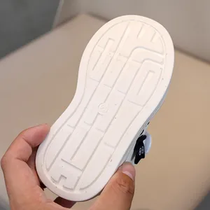 Detail of white rubber outsole with anti-slip geometric texture and size 28 marking