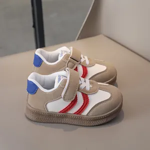 Detail of khaki kids sneakers featuring hook-and-loop closure and non-slip rubber soles