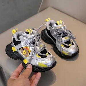 Detail of kids sporty sneaker with silver metallic finish and cute 3D bear character