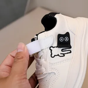 Macro detail of toddler sneaker with lychee leather, bear embroidery and velcro strap