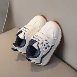 Detail of kids sneakers with panda patch, velcro strap and non-slip yellow sole