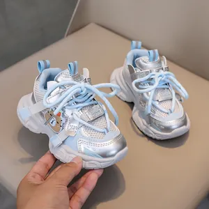 Detail of blue and silver kids mesh sneakers with bear patch and thick anti-slip sole