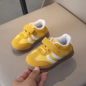 Detail of yellow toddler sneaker with non-slip rubber sole and velcro strap closure