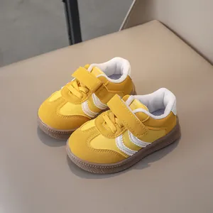 Detail of yellow kids sports shoes with suede texture, velcro strap and rubber sole