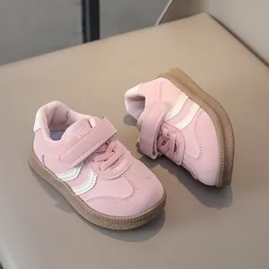 Close-up of pink kids sneakers showing soft synthetic leather and hook-and-loop closure