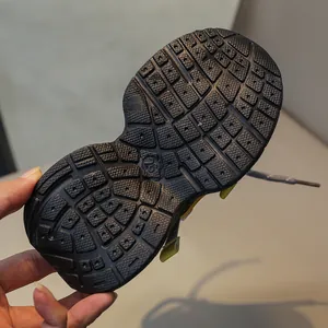 Close-up of non-slip rubber sole on kids sports shoes with size 26 marking