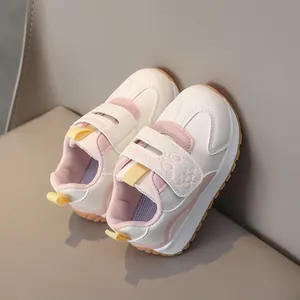 Close-up of children's sneakers featuring a cute cartoon rabbit and Velcro fashion strap
