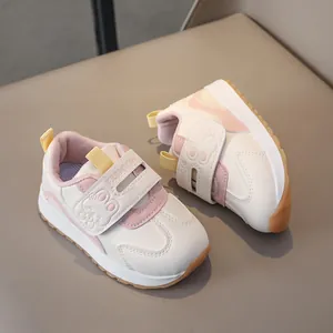 Detail of toddler sneakers with cute rabbit motif and secure magic tape closure