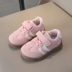 Detail of pink toddler sneakers with velcro straps and non-slip rubber outsoles