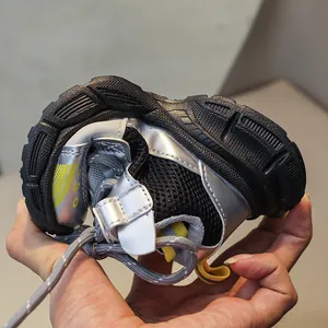 Detail of flexible black rubber sole on kids mesh running shoes showing durability