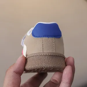 Close-up of non-slip rubber sole and blue heel detail on children sneaker shoes
