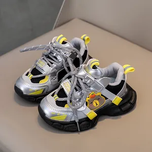 Breathable silver and black kids' sports shoes with yellow bear detail and mesh upper