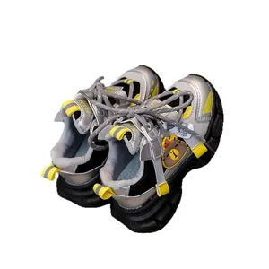 Kids sports sneakers in silver and yellow with a cute bear charm and mesh upper
