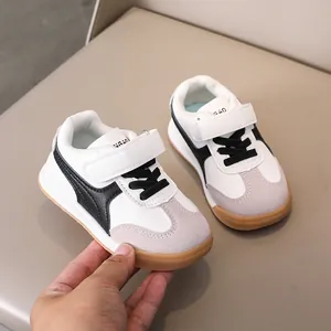 Close-up of kids' retro sports shoes with velcro straps and grey suede details