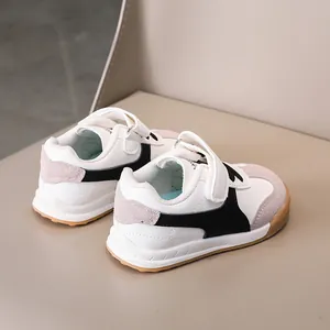 Detailed back view of kids' leather sneakers showing durable rubber soles and velcro straps