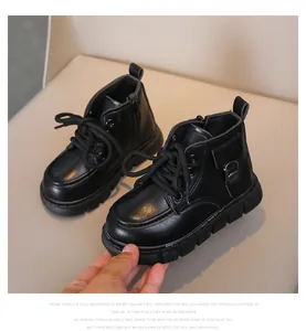Detail of kids black leather martin boots featuring sturdy laces and side zipper closure