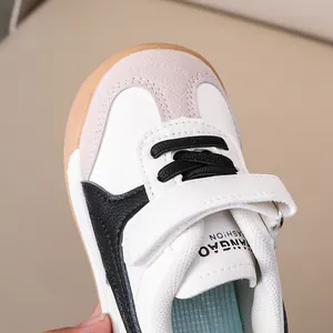 Close-up of kids leather trainers with suede toe and rubber sole in contrast colors