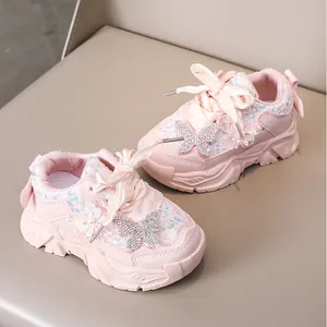 Gros plan de baskets roses pour fillettes avec papillon strass et dentelle