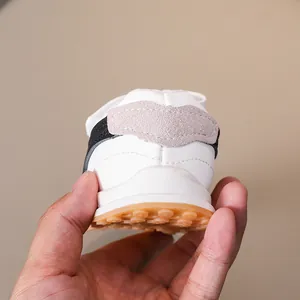 Close-up of kids retro trainers with textured rubber sole and soft leather heel detail