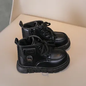 Detail of black children's boots with zipper, laces, and durable rubber sole