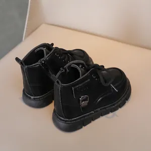 Detail view of children's black matte leather boots with side zipper and non-slip rubber sole