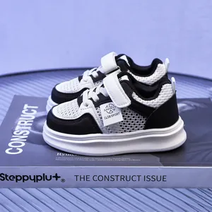 Kids' black and white mesh sneakers with breathable hollow design and Velcro closure
