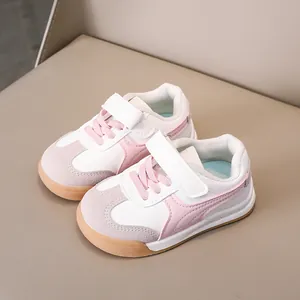 Pink and white low-top kids' leather sneakers with gum sole and velcro strap