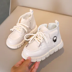 Detail of kids cream leather Martin boots featuring soft upper and non-slip rubber sole