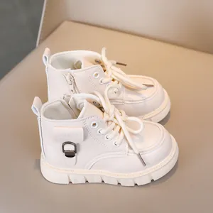 Detail of off-white kids martin boots with side zipper and rugged anti-slip rubber sole