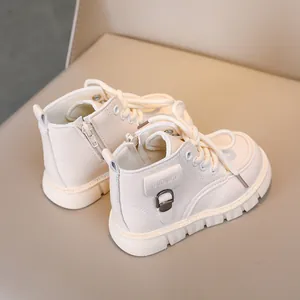 Detail of cream white kids Martin boots featuring side zipper and non-slip thick rubber sole