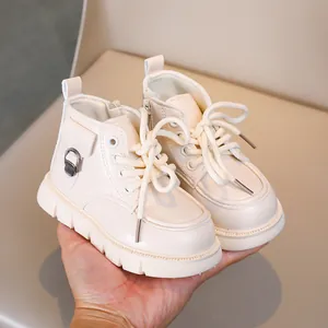 Close-up of beige children's Martin boots featuring side zipper and non-slip thick sole